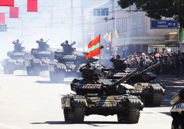 Tanks of Moldova’s self-proclaimed separatist Dnestr region move during a military parade during Independence Day celebration in Tiraspol